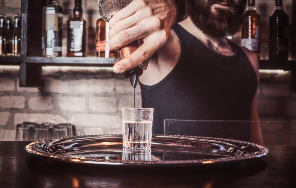 a bartender working behind the bar counter